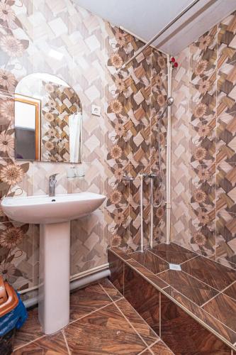 a bathroom with a sink and a shower at Major Guest House in Fergana