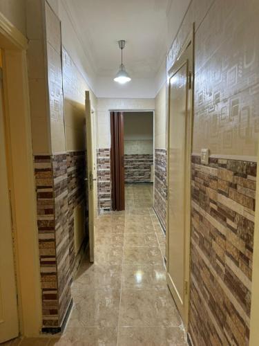 a hallway with brick walls and a hallway with a door at Decapolis 8 in Irbid