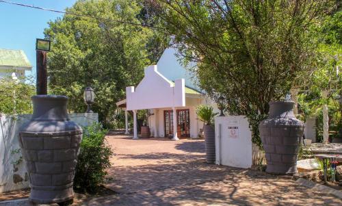 two large vases sitting in front of a house at The Fountain Villa in Klerksdorp