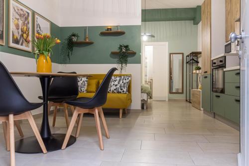 a living room with a yellow couch and a table at Airport Area Apartment With Free Parking in Bologna