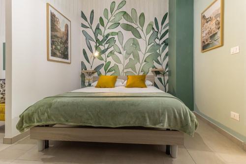 a bedroom with a large bed with yellow pillows at Airport Area Apartment With Free Parking in Bologna