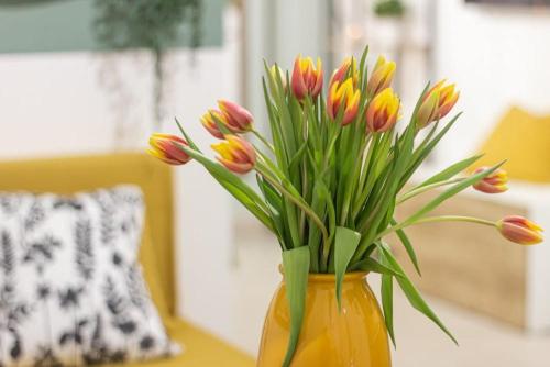 a vase filled with colorful flowers on a table at Airport Area Apartment With Free Parking in Bologna