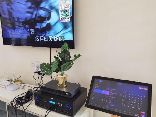 a desk with a computer and a monitor and a plant at 2 JB Adda Daya Setia Eco Austin 24paxs Pool Table Karaoke BBQ Corner Unit in Johor Bahru