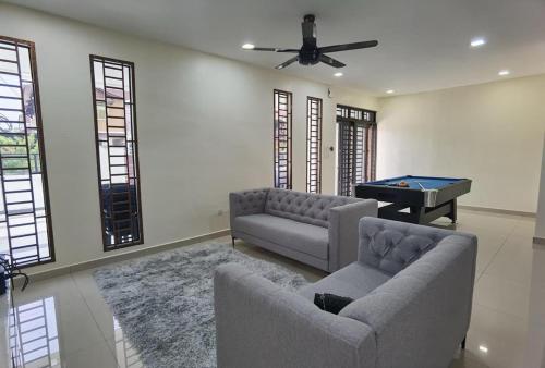 a living room with a couch and a pool table at 2 JB Adda Daya Setia Eco Austin 24paxs Pool Table Karaoke BBQ Corner Unit in Johor Bahru