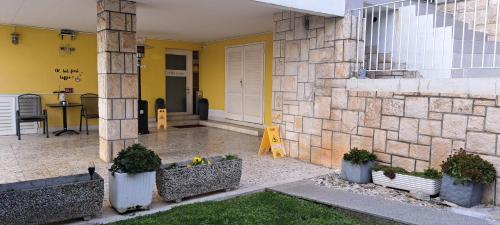 a front porch of a house with potted plants at Guest house Vila Luka 2 in Portorož