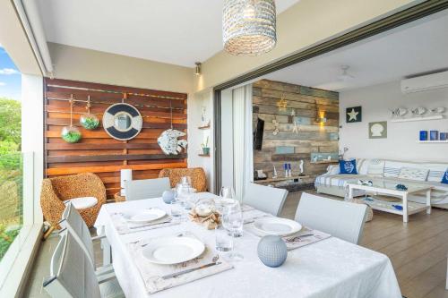 a dining room with a table and chairs and a bedroom at Orion Living - Walkable Facilities & Scenic View in Tamarin