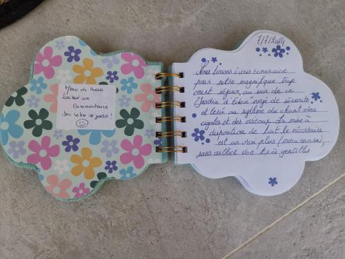 a notebook with a page of flowers on it at Maison de Charme en couleurs in Cuers