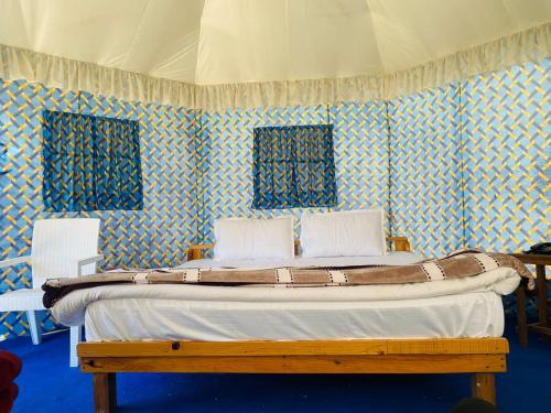 - une chambre dotée d'un lit avec du papier peint bleu et blanc dans l'établissement The malang valley resort with free parking and internet, à Nainital