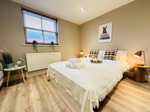 a bedroom with a large bed and a window at Modern Living City Centre Spacious Apartments in Hull