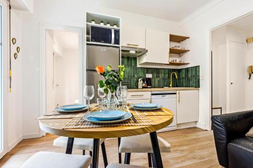 une cuisine et une salle à manger avec une table et des chaises dans l'établissement CASTEL II - Agréable deux pièces - Menton Centre, à Menton