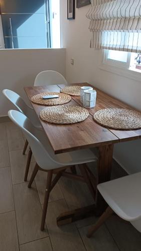a wooden table with four chairs and a box on it at Casa isabel in Setenil
