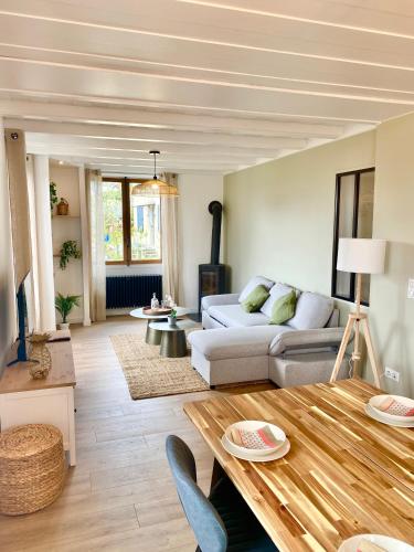 a living room with a couch and a table at Les Balcons de Chambéry in Chambéry