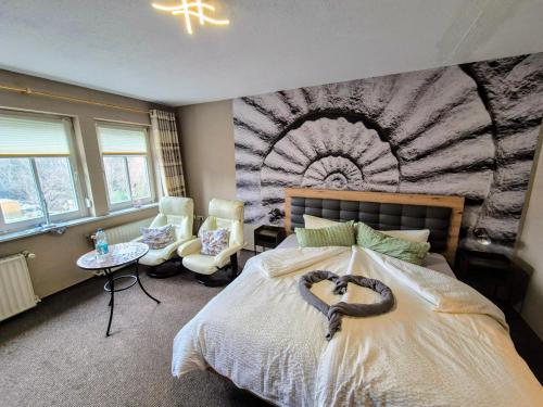 a bedroom with a bed with a heart carved on it at Altstadt Pension Orchidee in Wernigerode