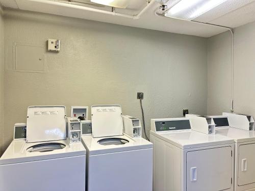 a laundry room with white washers and dryers at Studio 6 Springfield VA Washington DC Southwest in Springfield