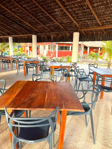 a group of tables and chairs in a restaurant at Pousada Ilha do Desejo in Olivença