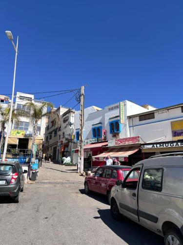 a group of cars parked on a city street at Guapa Surf Morocco in Taghazout