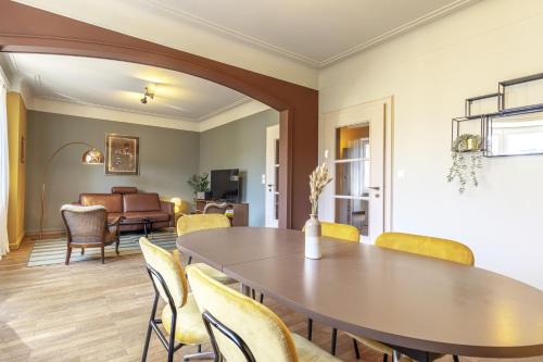 a dining room with a table and chairs at Elegant 2BR in Luxembourg with Balcony & WiFi in Luxembourg