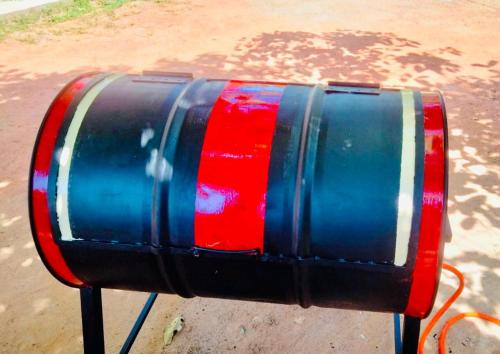 a red and blue barrel sitting on a tripod at Sea wind in Mirissa
