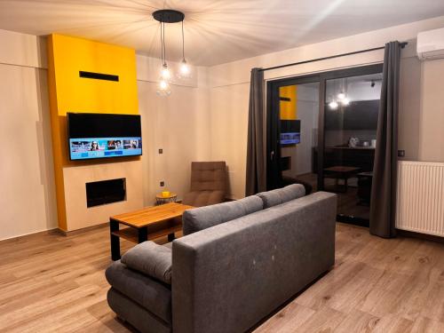 a living room with a couch and a table at The Olympus Balcony in Katerini