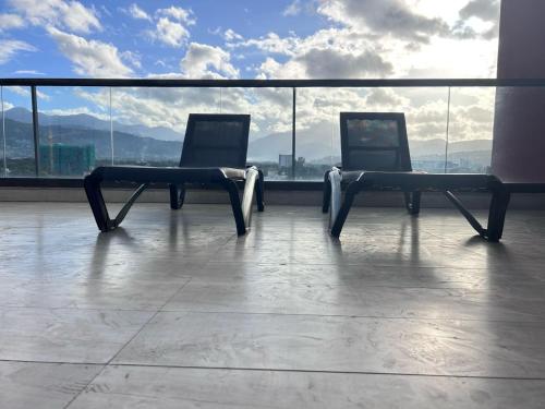 two benches sitting on top of a building at Luxury Suite kingston city view in Kingston
