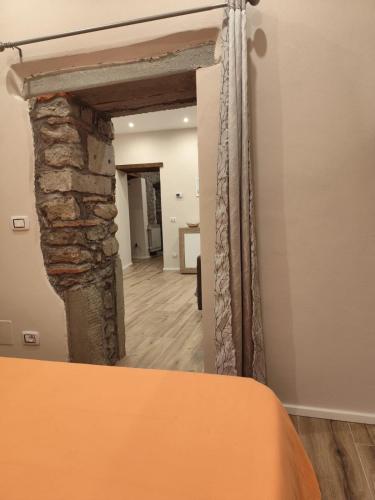 a view of a room with a stone wall at Kiki casina Piazza Lori in San Marcello Pistoiese