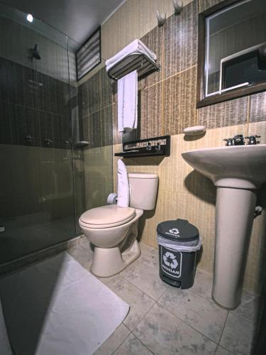 a bathroom with a toilet and a sink at Hotel Las Rocas Resort Villanueva in Villanueva