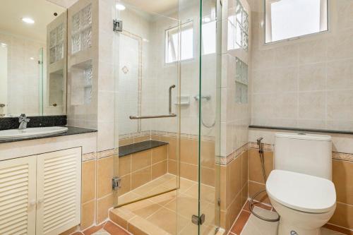 a bathroom with a toilet and a glass shower at Top family house in peaceful area with lake view 3BR 15 mins to city in Chiang Mai