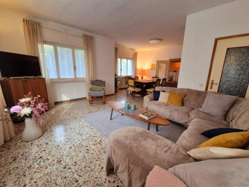 a living room with a couch and a table at Villa dei Pini in Laveno-Mombello