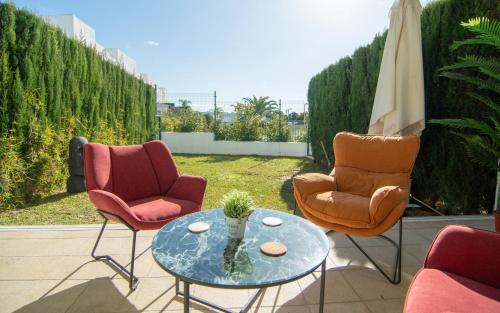 a patio with two chairs and a table with at Casa PLAYA FONTANILLA in Conil de la Frontera