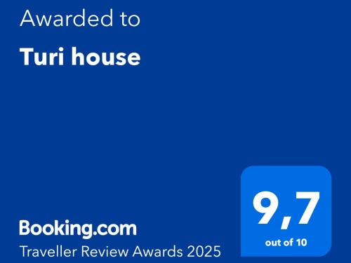 a blue screen with the text awarded to tshirt house at Turi house in Messina