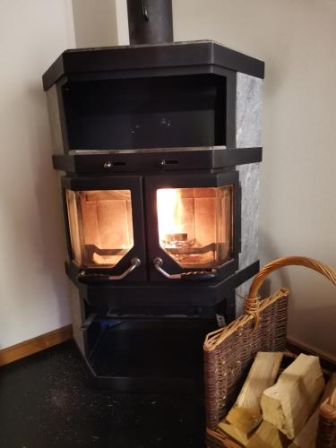 a stove in a room with a fireplace at Alpenrose Aletsch Landschaftspark Binntal in Grengiols