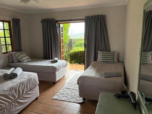 a living room with two beds and a couch at The Gem Emerald in Graskop