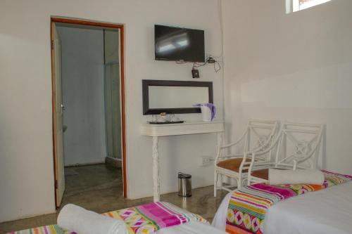 a living room with a table and a mirror at The Fountain Villa in Klerksdorp
