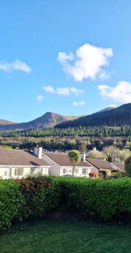 a group of houses with mountains in the background at Mourne Mountains holiday home in Newcastle