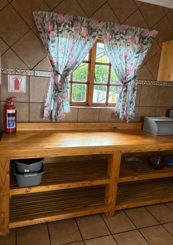 a wooden counter with a window in a kitchen at The Gem Emerald in Graskop