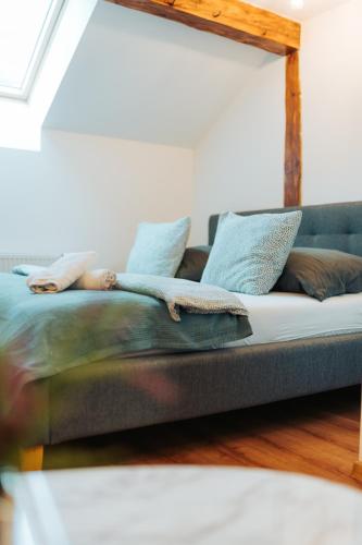 a couch with pillows on it in a room at Apartmány J&J in Šumperk