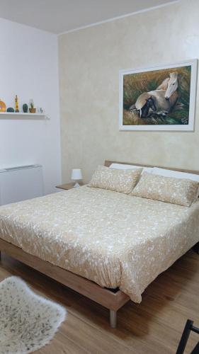 a bedroom with a bed and a painting on the wall at Regina di Puglia in Santeramo in Colle