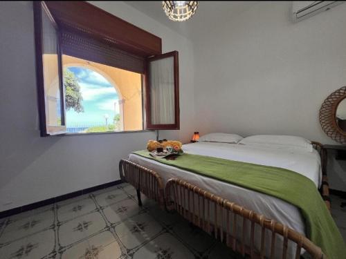 a bedroom with a bed with a teddy bear sitting on it at Casa Hibiscus - Fronte Mare in Paparella