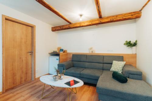 a living room with a couch and a table at Apartmány J&J in Šumperk