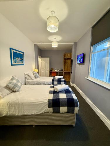 a bedroom with two beds and a window at The Crescent York in York
