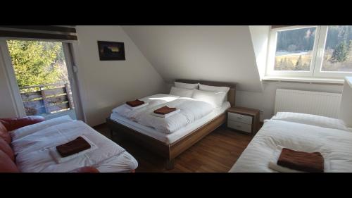 a small room with two beds and a couch at Ferienwohnung Michelle mit Balkon für 1 - 6 Personen in Warmensteinach