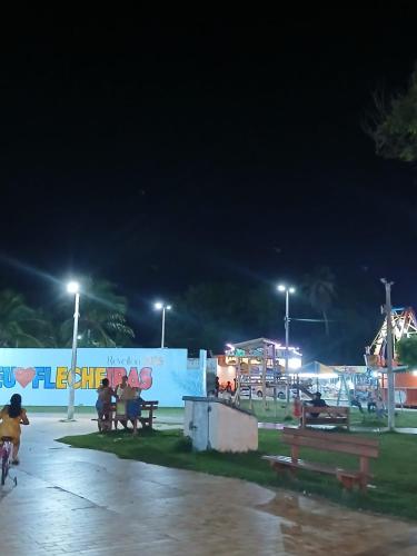 a group of people sitting at a park at night at Cantinho do sossego in Trairi