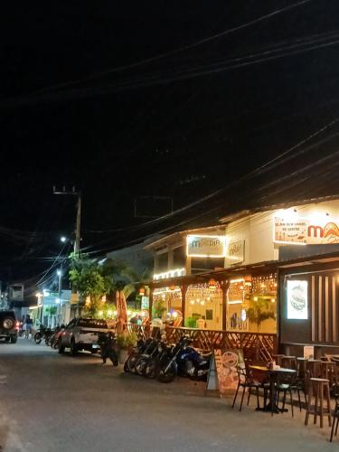 a group of motorcycles parked outside a building at night at Cantinho do sossego in Trairi