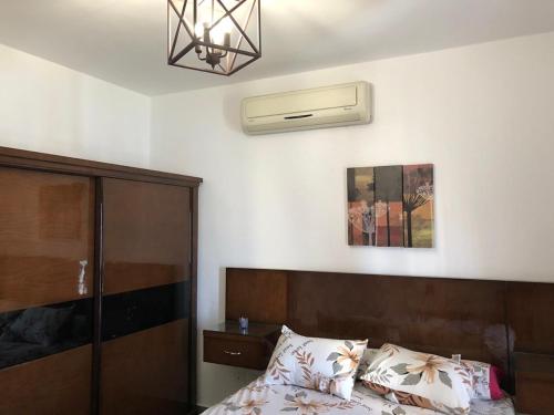 a bedroom with a bed and a ceiling fan at 2BR Amwaj Terrazza & Piscina in Marsa Matruh