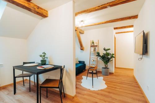 a living room with a table and a couch at Apartmány J&J in Šumperk