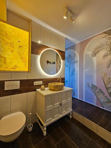 a bathroom with a sink and a toilet at Stylish Forest View - Apartment in Augsburg