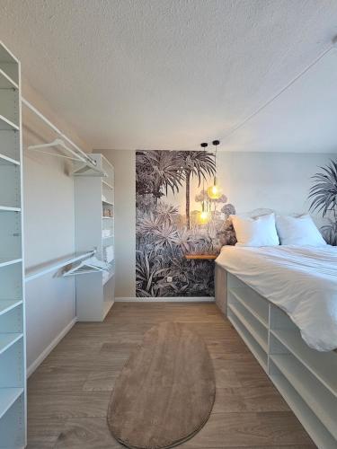 a bedroom with a bed and a painting on the wall at Stylish Forest View - Apartment in Augsburg