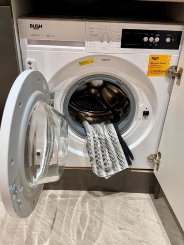 a washing machine with its door open in a room at 267 Stylish 2 Bed Apartment City Centre Free Parking in Cardiff