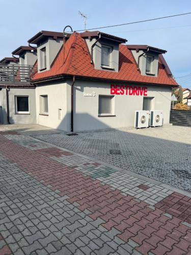 a building with a sign that reads bestdrive at Bestdrive Pokój 6 in Babienica