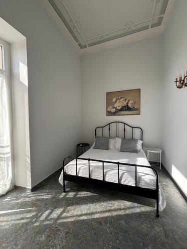 a bedroom with a bed in a white room at Casa di Gilda in Ospedaletti